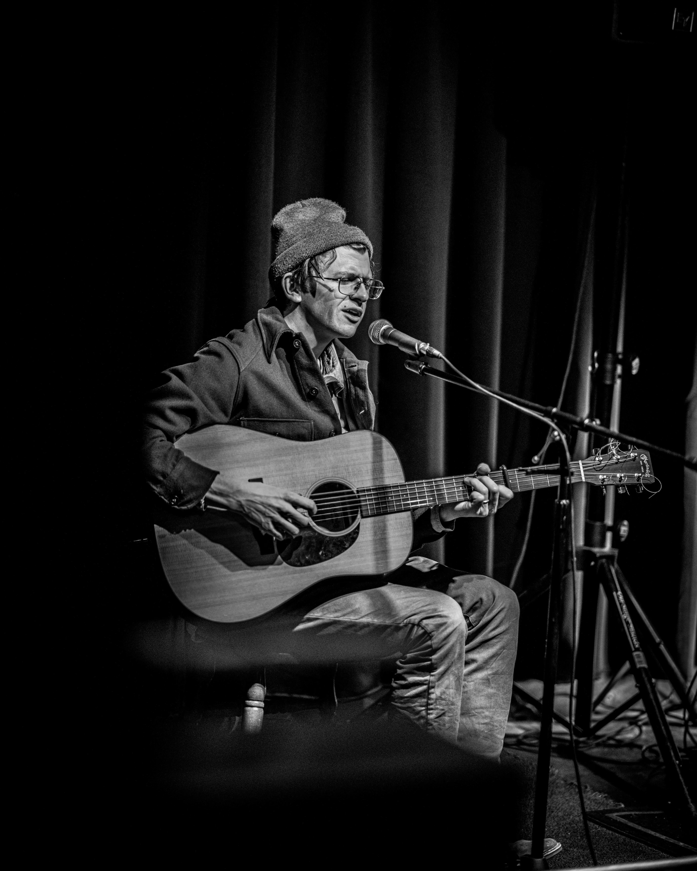 Sam Steffen playing guitar at O'Michael's open mic in Boise ID